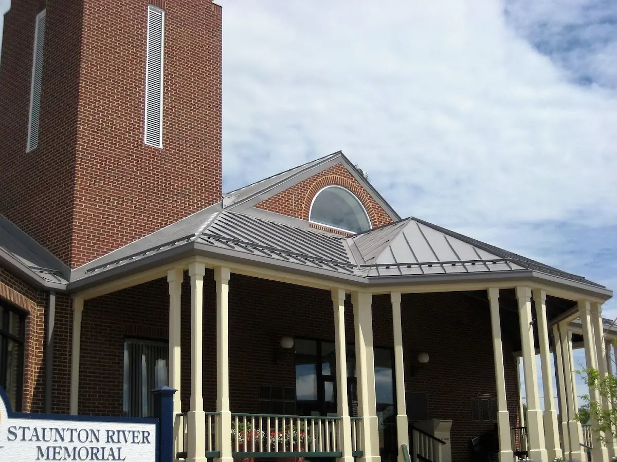 Skilled roofing craftsmen working on a residential roof in Avenel
